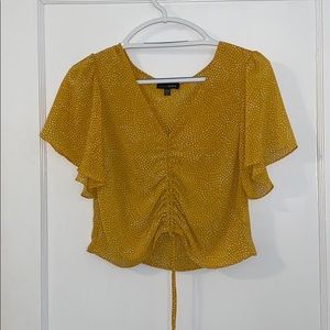 Lucy Paris yellow and white spotted crop top